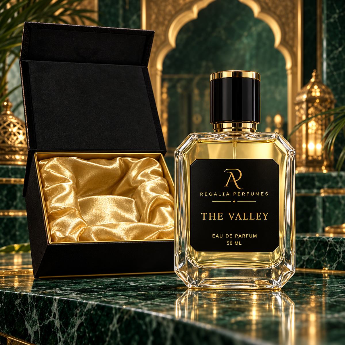 The Valley transparent perfume bottle with gold R/P logo and gold satin presentation box